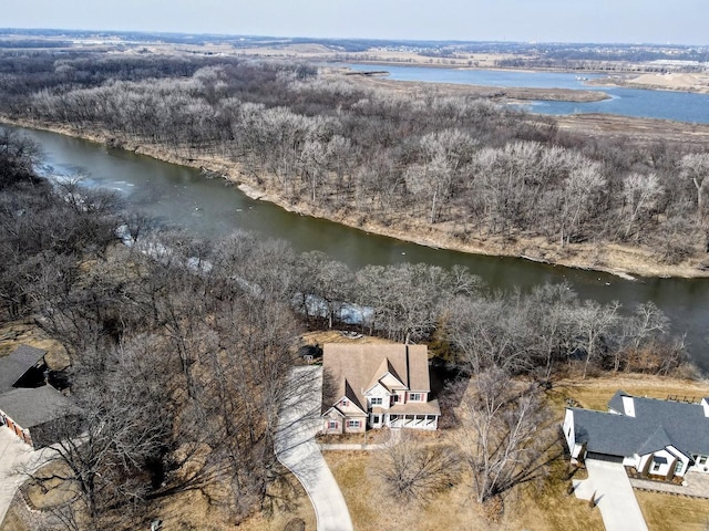 aerial view with a water view and a wooded view