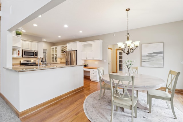 dining area with light wood-type flooring, baseboards, and recessed lighting