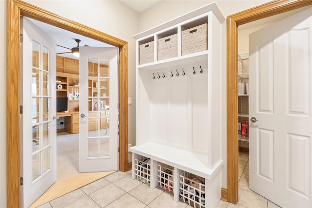 mudroom with tile patterned flooring, french doors, and ceiling fan