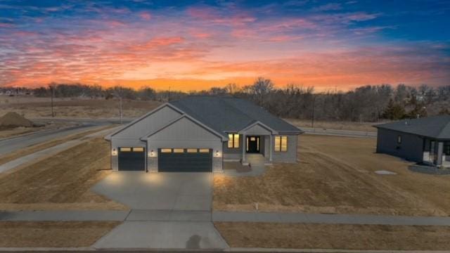 modern inspired farmhouse featuring a garage and concrete driveway