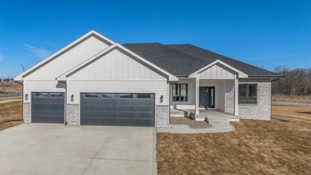 view of front facade featuring a garage, driveway, and board and batten siding