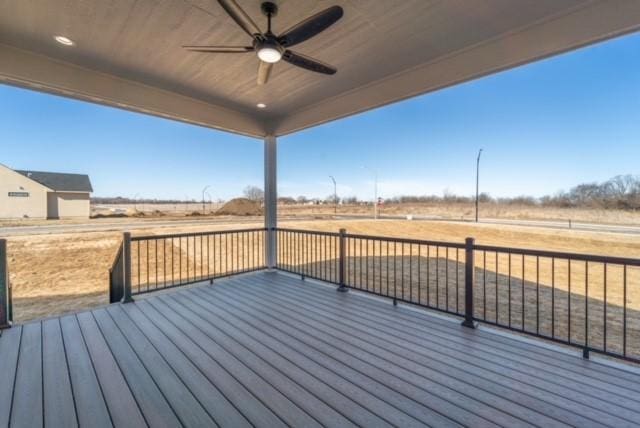 deck with a rural view and ceiling fan