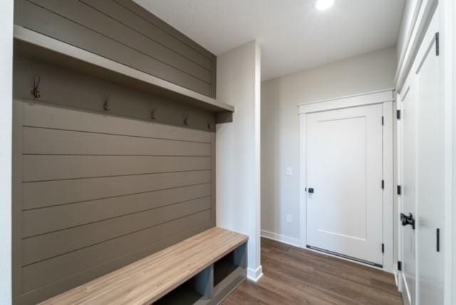 mudroom with baseboards and wood finished floors