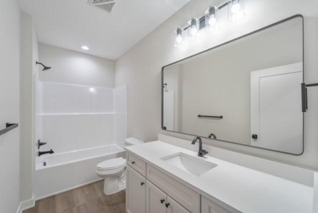 full bathroom with shower / bathtub combination, visible vents, toilet, vanity, and wood finished floors