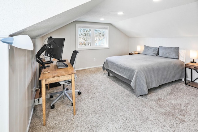 carpeted bedroom featuring lofted ceiling and baseboards