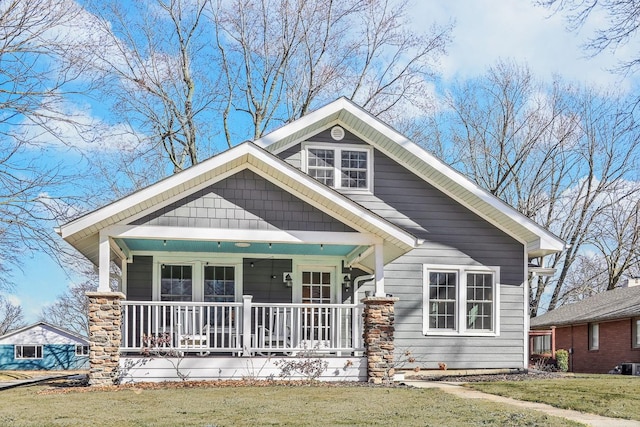 view of front of house with a porch and a front lawn