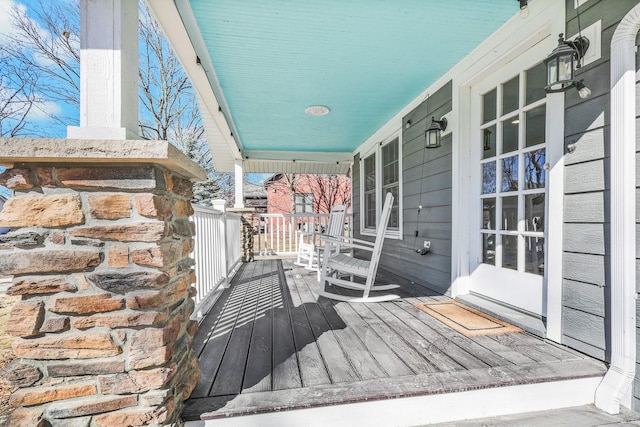 wooden terrace featuring covered porch