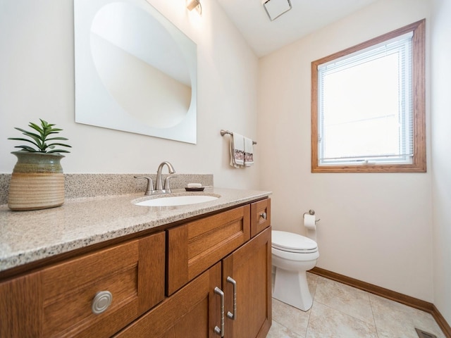 bathroom featuring tile patterned floors, toilet, vanity, and baseboards