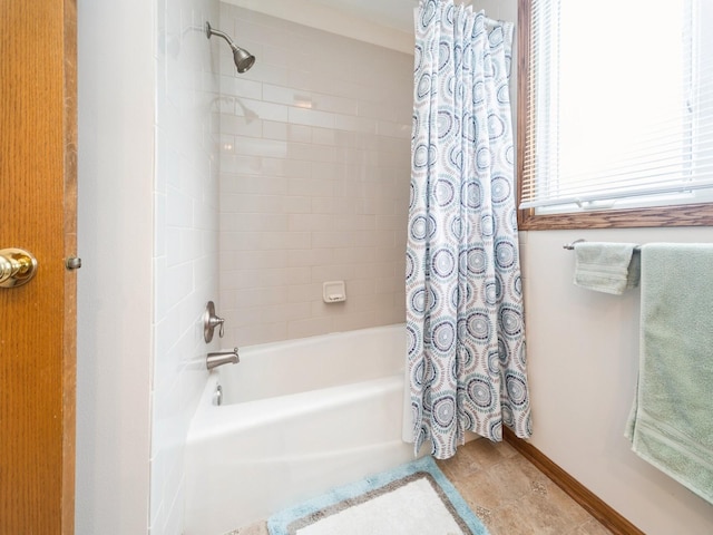 full bath with baseboards, shower / tub combo, and tile patterned flooring