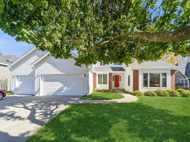 view of front facade with a garage, driveway, brick siding, and a front yard