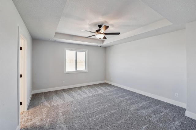 2208 White Oak Ln, Granger, IA 50109 - carpeted spare room with a tray ceiling, ceiling fan, and baseboards