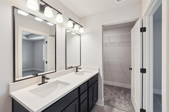2208 White Oak Ln, Granger, IA 50109 - full bathroom with a spacious closet, double vanity, and baseboards