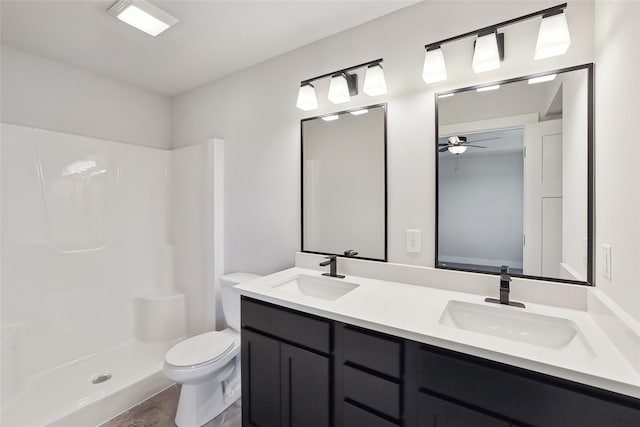 2208 White Oak Ln, Granger, IA 50109 - bathroom featuring toilet, ceiling fan, a shower, and double vanity