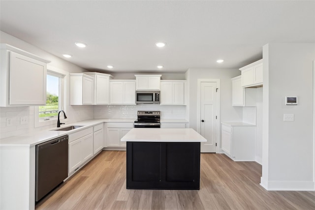 2208 White Oak Ln, Granger, IA 50109 - kitchen featuring stainless steel appliances, a sink, light wood-type flooring, decorative backsplash, and recessed lighting