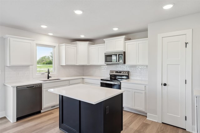 2208 White Oak Ln, Granger, IA 50109 - kitchen featuring appliances with stainless steel finishes, a sink, white cabinetry, and recessed lighting