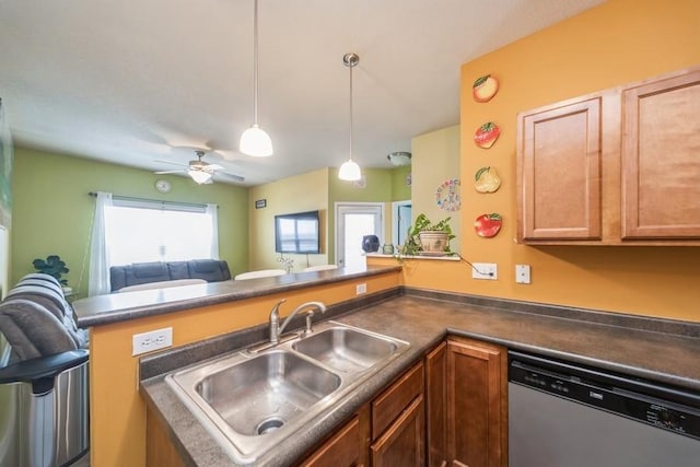 kitchen with stainless steel dishwasher, a peninsula, dark countertops, and a sink