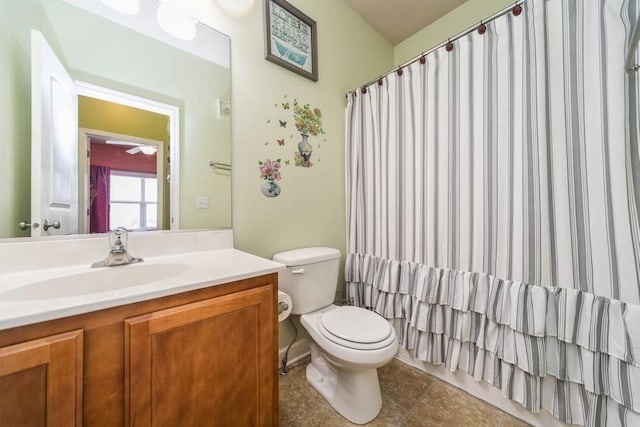 bathroom featuring vanity, tile patterned floors, and toilet