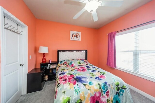 bedroom featuring baseboards, carpet, and a ceiling fan