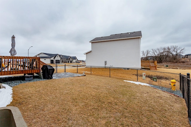 view of yard featuring a deck and fence