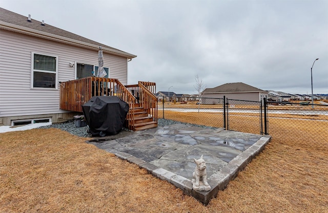 view of yard with a gate, a wooden deck, and fence