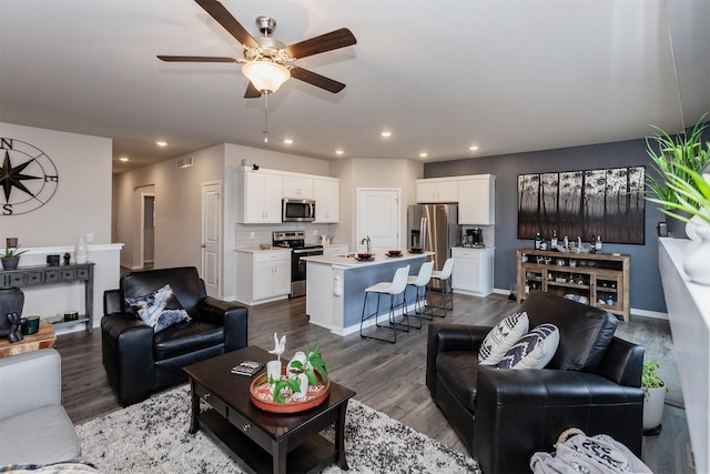 living area with recessed lighting, visible vents, baseboards, and dark wood-style floors