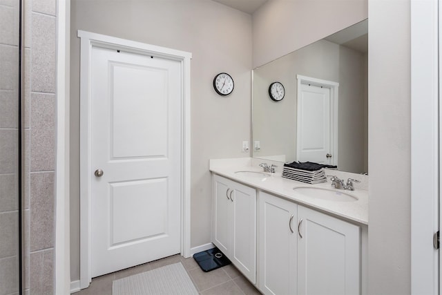 bathroom featuring tile patterned flooring, double vanity, and a sink