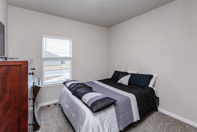 carpeted bedroom featuring baseboards