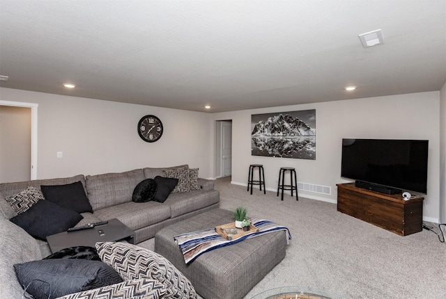 carpeted living room with visible vents, recessed lighting, and baseboards