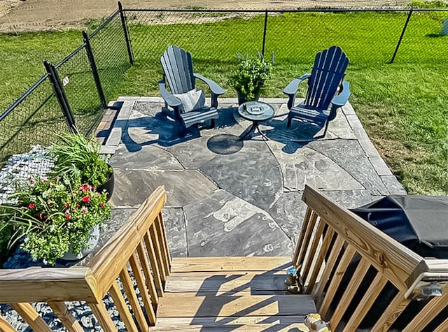 view of patio with a deck and a fenced backyard