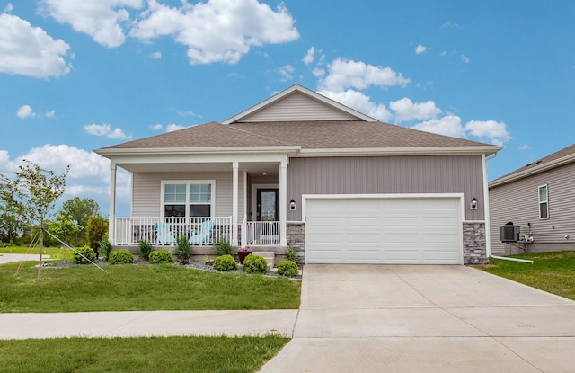9904 NW 82nd Ave, Johnston, IA 50131 - single story home featuring stone siding, a porch, a front lawn, and a garage