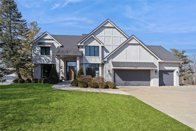 view of front of home featuring brick siding, a shingled roof, a front yard, a garage, and driveway