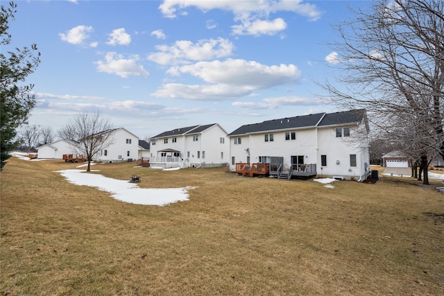 back of house with a lawn, a residential view, and a wooden deck