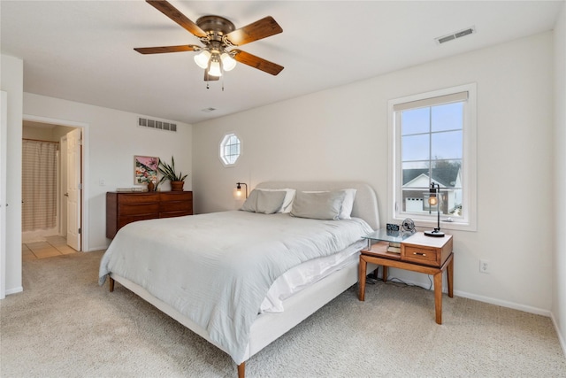 bedroom featuring light carpet, visible vents, a ceiling fan, and baseboards