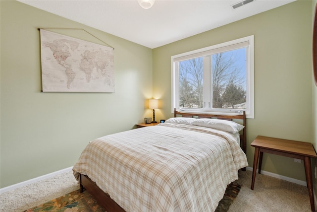 carpeted bedroom with visible vents and baseboards