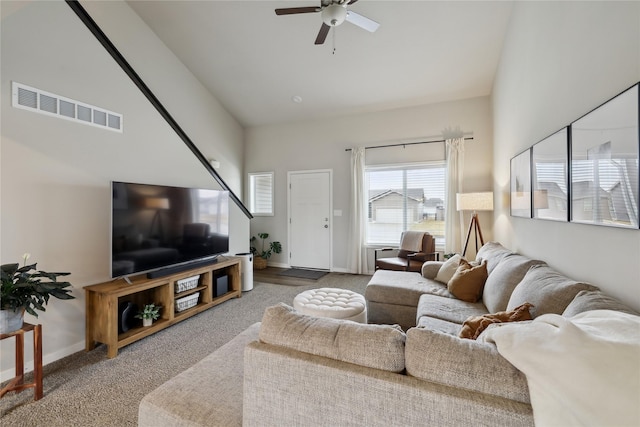 living room featuring visible vents, baseboards, carpet floors, and a ceiling fan