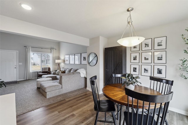 3325 Wolf Creek Rd SW, Bondurant, IA 50035 - dining area featuring baseboards and wood finished floors