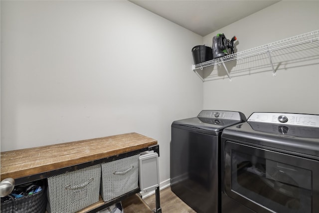3325 Wolf Creek Rd SW, Bondurant, IA 50035 - clothes washing area featuring baseboards, washing machine and dryer, wood finished floors, and laundry area