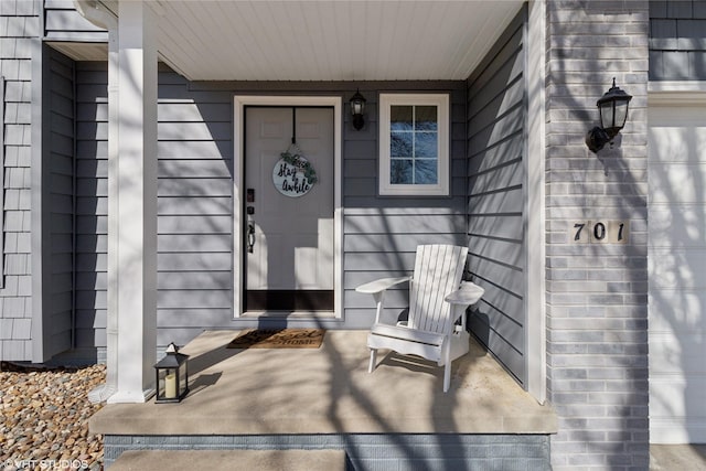 view of exterior entry with covered porch