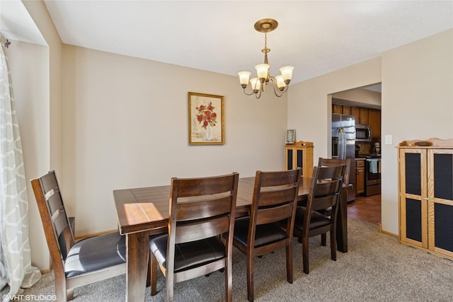 dining area featuring baseboards, light colored carpet, and an inviting chandelier