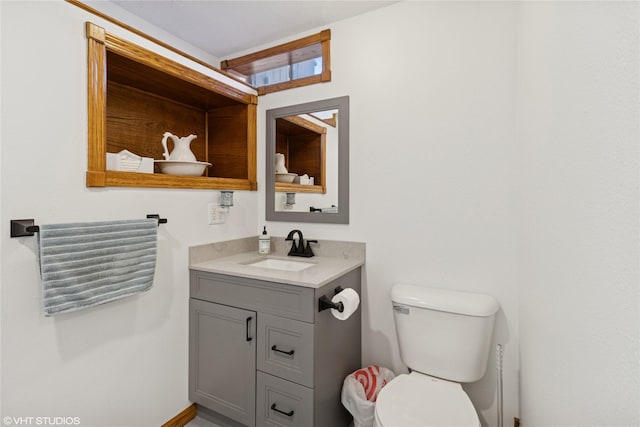 bathroom with toilet and vanity