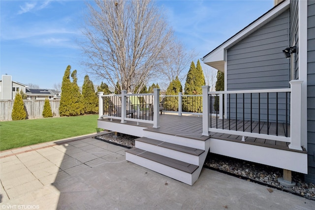 deck featuring a yard, fence, and a patio area