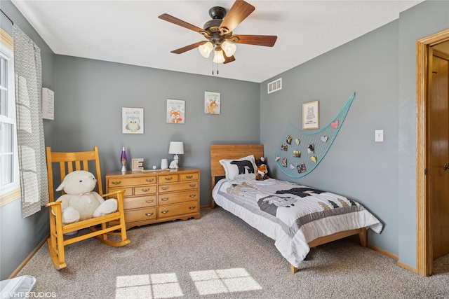 bedroom featuring carpet flooring, baseboards, visible vents, and ceiling fan