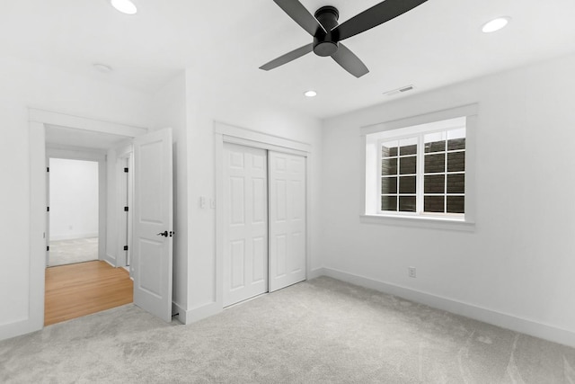 unfurnished bedroom with carpet flooring, recessed lighting, baseboards, and visible vents