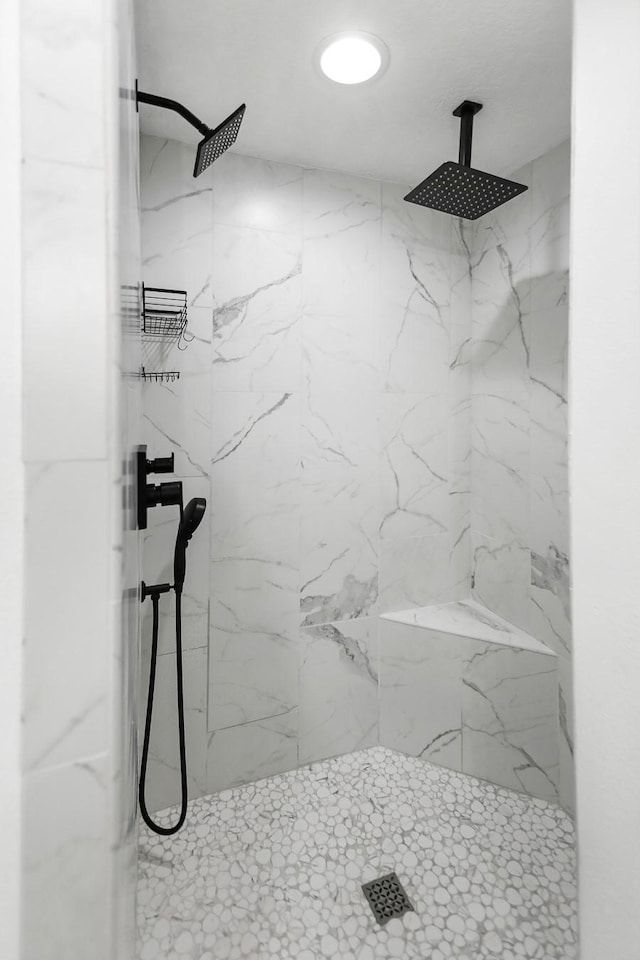 full bathroom featuring a marble finish shower