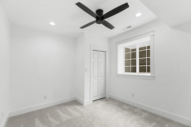 unfurnished bedroom with visible vents, baseboards, recessed lighting, ceiling fan, and light colored carpet