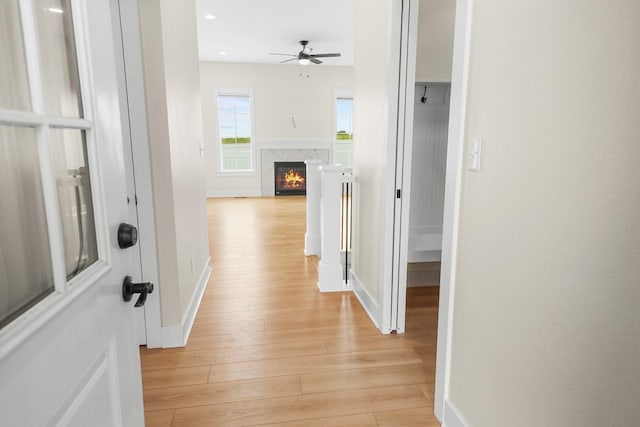 hall with recessed lighting, baseboards, and light wood-style floors