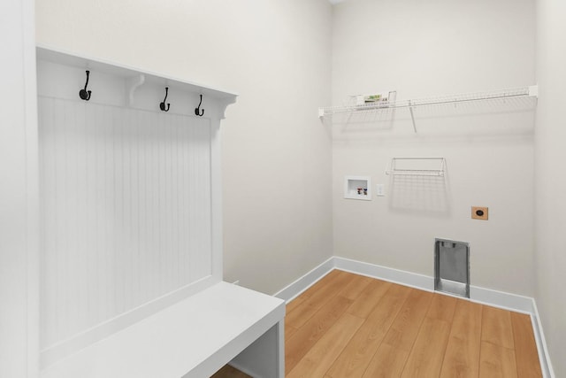 mudroom with baseboards and light wood-style floors