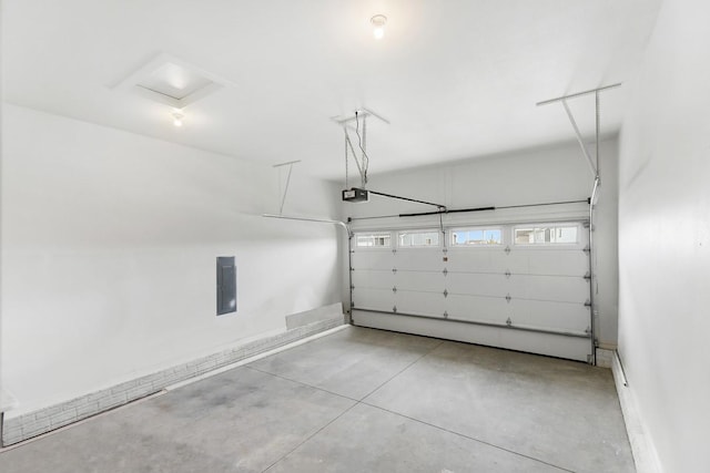 garage featuring a garage door opener and baseboards