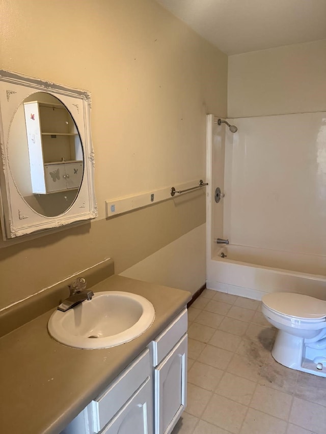 bathroom featuring bathing tub / shower combination, toilet, vanity, and tile patterned flooring