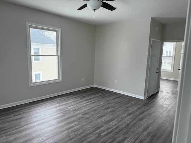 empty room with baseboards, a textured ceiling, ceiling fan, and dark wood-style flooring